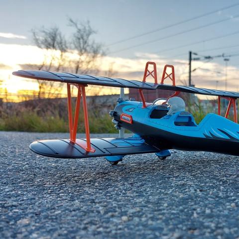 Avião bimotor azul playmobil na rua. Ao fundo o por do Sol