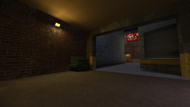 In this picture you can see the opposite perspective of the last picture of the previous photo series. From left to right you can see the yellow illuminated lamp, the dumpster, a passageway where you can see a white building on the left, a brick building with a boarded-up entrance door where a yellow illuminated lamp hangs above it from the entrance ceiling, a window with a grille and at the top of the brick building hangs a billboard of popdog, the creators of the map, whose logo is a comic Dalmatian. On the right-hand side behind the passageway is a loading zone for trucks. This is on the map cs_backalley in the game Counter-Strike 1.6.