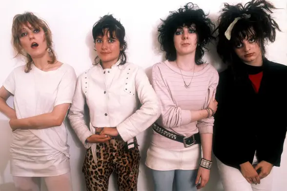 A photo of four members of the band the Slits which formed in London 1976. All wearing pink except for Ari Up on the right end wearing black.