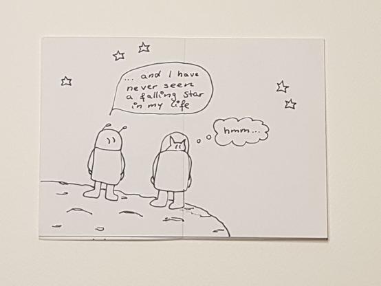 double spread in the mini-zine. Hand drawn comic. Two figures on a planet one saying "and I have never seen a falling star in my life"