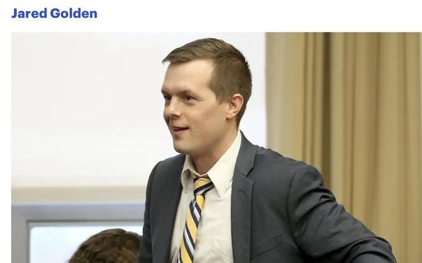 Color picture off white man in dark suit with yellow, blue, white stripes