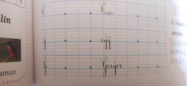 Écriture cursive de la lettre G.