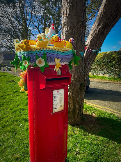 Post box with knitted topper depicting Easter