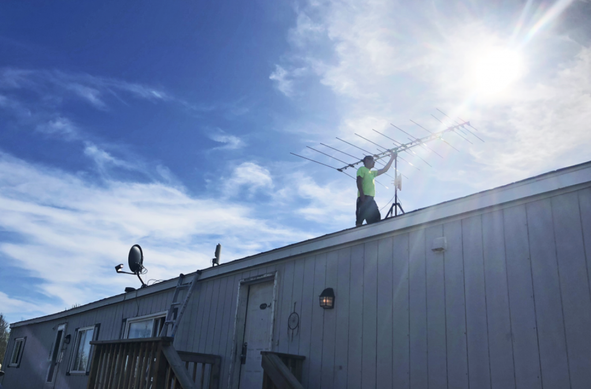 Bruce buffalo on a roof adjusting a panel