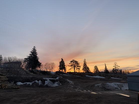 The sun is rising. There are bright yellow and orange streaks
