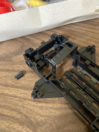A chunk of the motor mount is missing and the rest is bent and cracked.