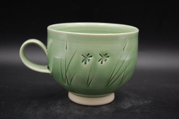 Large cup with one finger handle. Spring green with dragonflies in the long grass