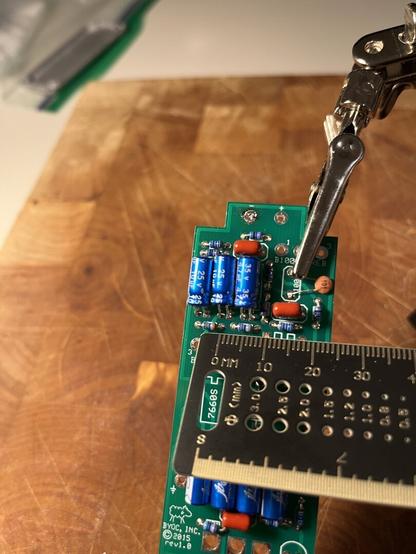 Even closer shot showing the small resistors next to a millimeter-scale ruler.