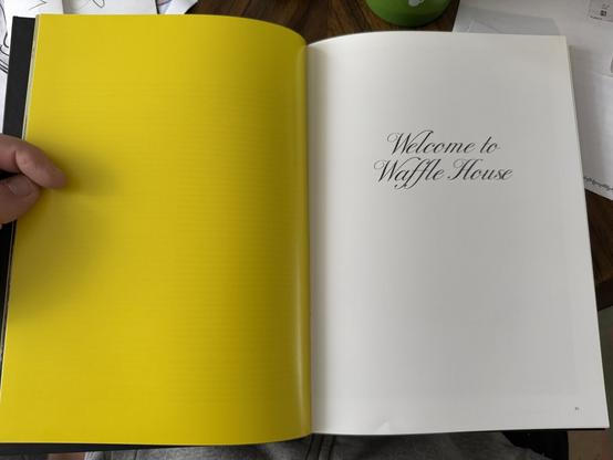 Open book, page on the left is a bright yellow. The page on the right is white and in cursive black print it reads "Welcome to Waffle House"