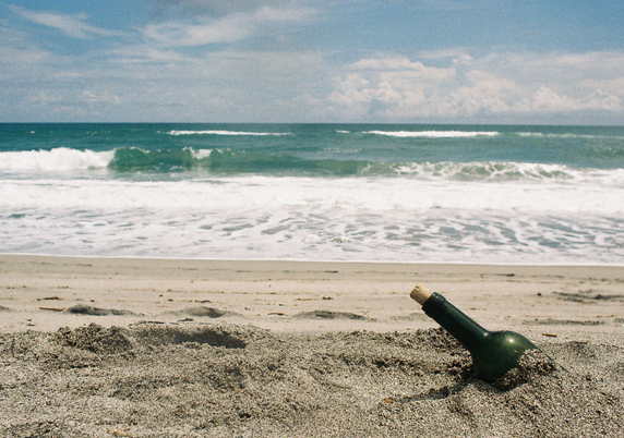Bottle half-buried at the beach.
