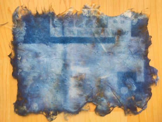 Similar print with obscured images, one of an archival newspaper article with test that reads "the earth, the seasons, and the weather"
