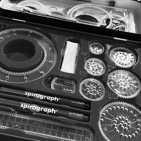 Black and White close up of a spirograph set.