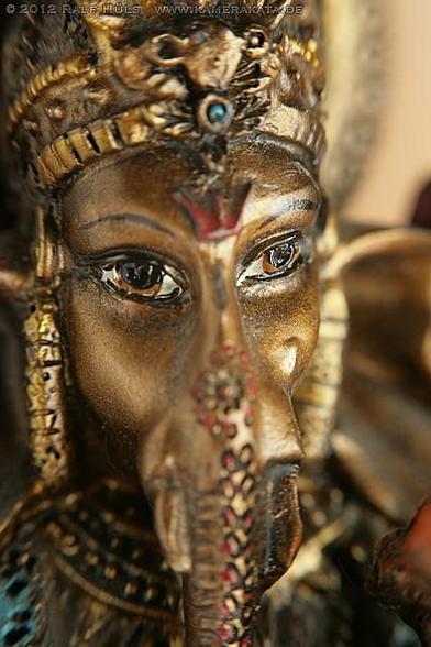 Macro shot of the face of a small statuette of Lord Ganesha