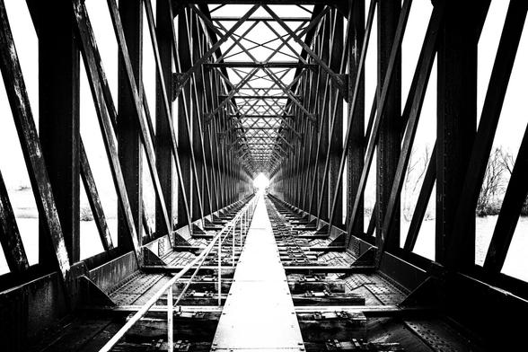 view over an old lattice truss bridge
