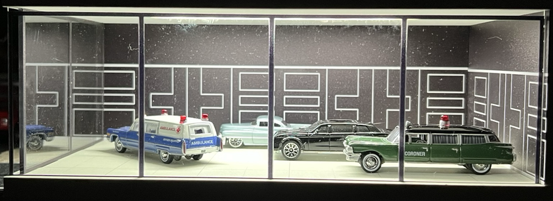 A toy showroom with model cars arranged to look like an actual 1950s car dealership showroom.