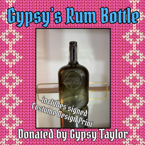 Picture of a flash auction item donated by Gypsy Taylor: Gypsy's Hand-Blown Rum Bottle. A photo shows a green glass rum bottle stamped with the show's logo. 'Includes signed costume design print!' is written at the bottom of the photo.