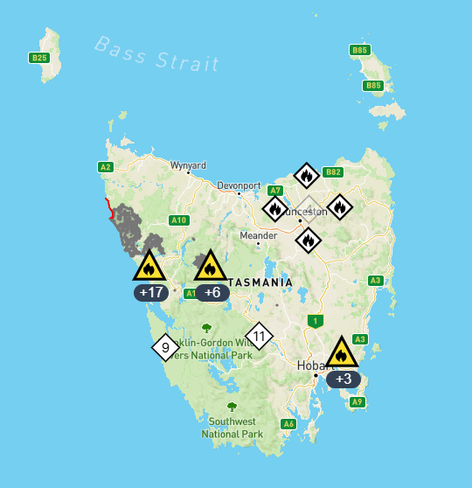 A map of Tasmania with icons denoting where bushfires are located. There are four fires surrounding Launceston, all white icons which means they are being watched but not serious. There are others in Tassie as well, some yellow which means they are actively fighting them.