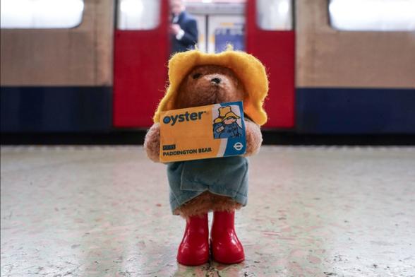Paddington holding an Oyster card