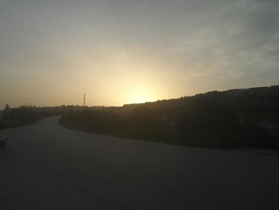 sun rise over the hill in Garghur, looking from the Naxxar gap, the sky is lit up with golden hues, as the sky begins it change from the inky blue of night, to the powder blue of the morning. In the distance is the TV tower, silhouetted in the morning sun