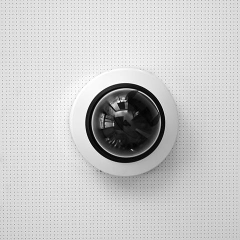 A spherical surveillance camera on a ceiling in a bank. Reminds of HAL in Kubrik's Space Odyssey