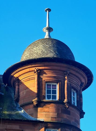 A corner tourelle topped by an ogee dome on a Glasgow Style Victorian building.