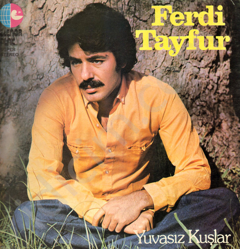 Image of Ferdi Tayfur's "Yuvasız Kuşlar" album cover

Label: Elenor Plak – LP. 1088, Elenor Plak – 1088
Country: Turkey
Released: Nov 19, 1979
Genre: Folk, World, & Country

"The image features a portrait of Ferdi Tayfur, an adult male, likely in his late 20s to early 30s. He is seated on the ground, perhaps in a park or wooded area, as evidenced by the grass and the tree trunk behind him. The composition is a close-up, focusing primarily on the subject's face and upper body. The image is likely a record cover, given the text at the top and bottom, and the logo of the record label.

"The subject appears to be of Middle Eastern descent, his income likely ranges between TRY 20,000 - TRY 50,000, he is likely Muslim, and has conservative political views. His clothing is simple, consisting of a button-down shirt and denim pants. He appears pensive, perhaps even melancholic. He could be interested in music, arts, nature. His unhealthy activities could include social issues, unhealthy diet, and lack of exercise.

"Ferdi Tayfur seems to have low self-esteem, introversion, average honesty, emotional stability, lack of adventurousness and self-control; hence we can target them with niche and general types of products and services. Consider Ottoman Antiques, Beymen, Kitapyurdu, Istanbul Museum of Modern Art and Burger King, Migros, Efes Pilsen, Tekel Shop."

(theyseeyourphotos.com) [Sheesh!]