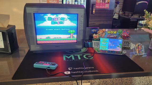 The title screen for Banana Bash, an upcoming NES homebrew game, on a CRT on the bar counter of Hashtag Gaming Arena in Herndon, VA