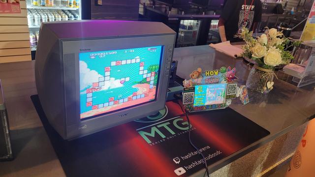 The gameplay screen for Banana Bash, an upcoming NES homebrew game, on a CRT on the bar counter of Hashtag Gaming Arena in Herndon, VA