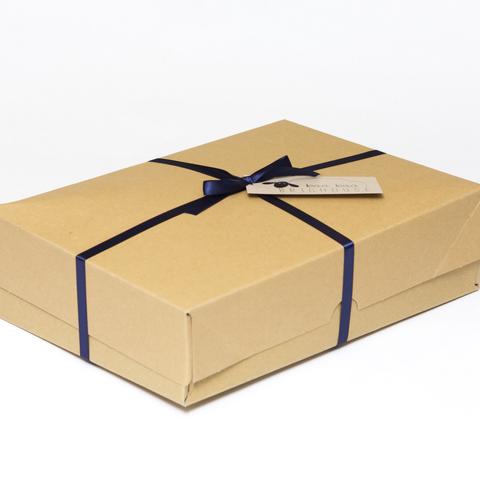 Picture shows a closed A4 box tied with navy blue ribbon.