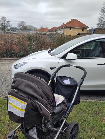 Trolly in front of a Tesla