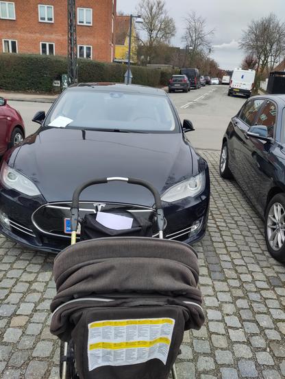 Trolley in front of a Tesla