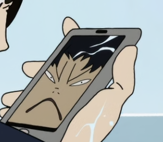 Screenshot from Devilman Crybaby of a phone with Akira's face in chibib form making a >:( face