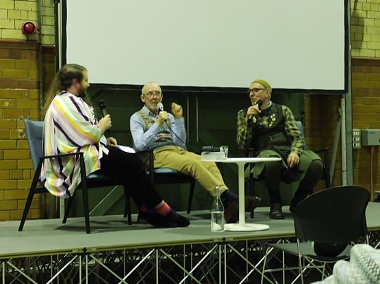 Young non-binary historian Jaime Starr chairs the discussion with older men Mike Jackson and Jonathan Blake, both veteran gay activists and LGSM members, at the People's History Museum.