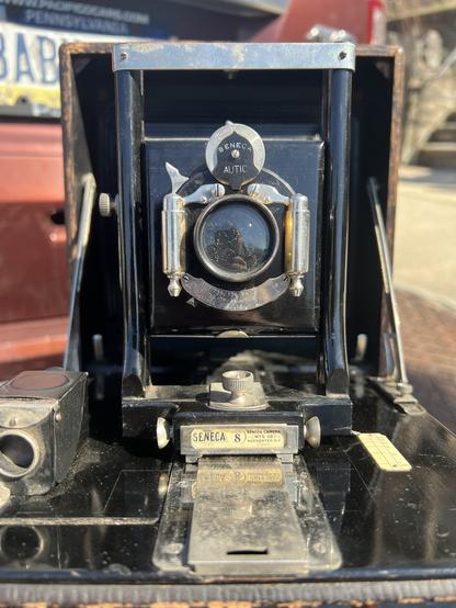 A head on view of the Seneca 8, showing its nicer Autic pneumatic shutter after I cleaned it up and got it operating smoothly again. Also visible is the nice Seneca 8 tag below the front standard.