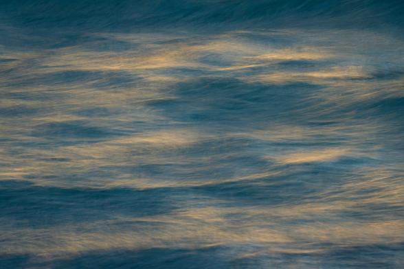 Blue waves with bright  sunlight reflections