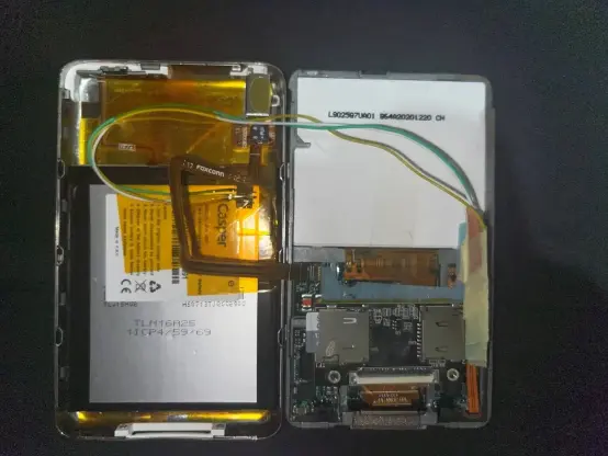 ipod 5th gen opened, modified with a micro sd card module and 3rd party battery retro fitted into the case.