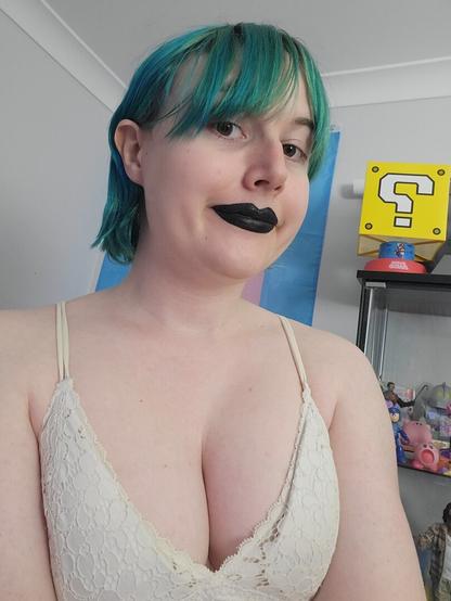 Revy with her blue hair tied back abit
She's wearing black lipstick and a cute white lace bra
Her borbs be big
She has a Mario ? box in background