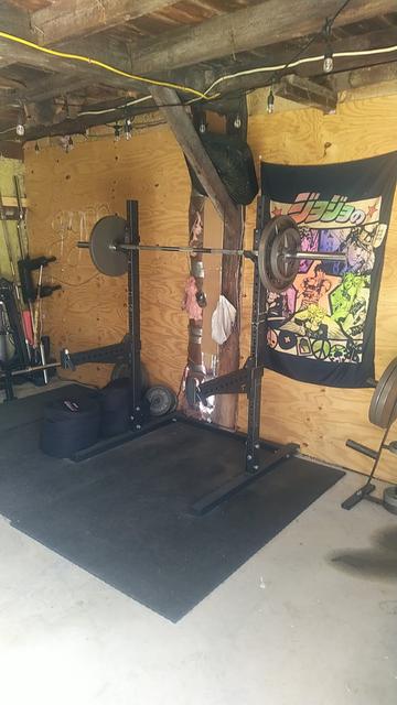 The squat rack with a barbell loaded up to 185lbs/some amount of KG.