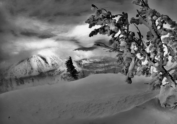 Like being in a winter’s dream, the frosty landscape is muted on the mountain, with puffy clouds and mist hanging on like a veil of white.