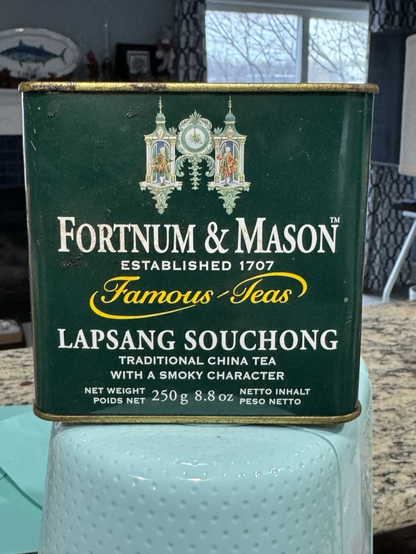 A green Fortnum & Mason tea tin reading Lapsang Souchong.