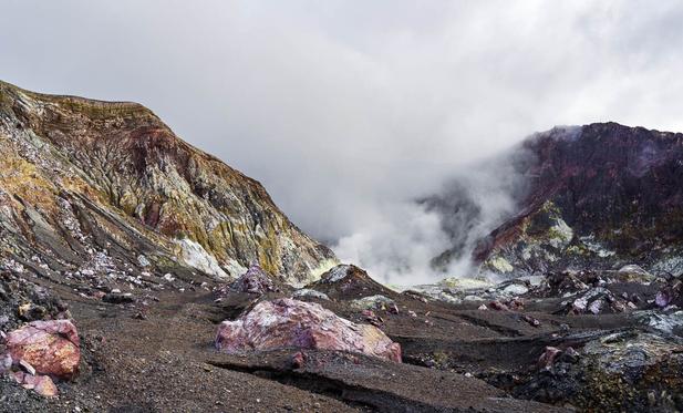 Steam and gas rise from the colorful volcanic landscape of White Island (Whakaari), New Zealand’s most active volcano, captured in 2019 before its eruption.