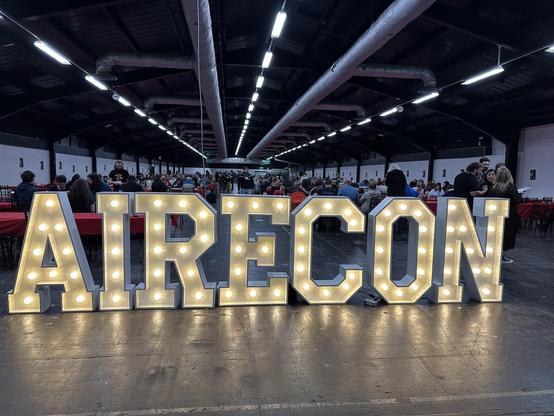 The big lamp lit Airecon sign at the entrance to one of the halls.