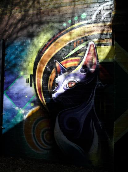 A painting of a cat outside the bridge
