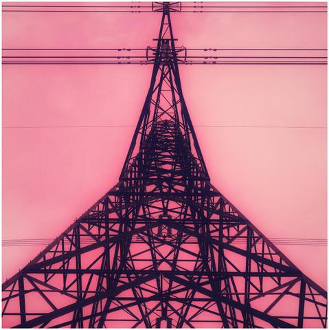 Symmetrical view looking up at an electricity outlook in a simulated redscale style.