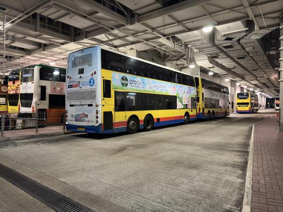 Viele Doppelstockbusse stehen hintereinander nebeneinander geparkt in einer Halle