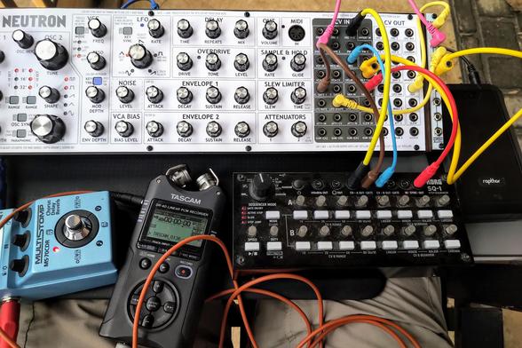 My music gear on a lapdesk on my lap, with me sitting in a rocking chair outside