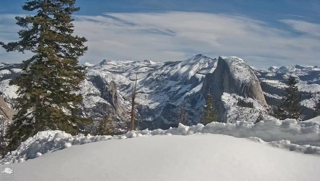 Sunshine at the high elevations today in Yosemite National Park. Snow in the foreground, Half Dome in the middle, and a partly blue sky above in this Yosemite Conservancy image.