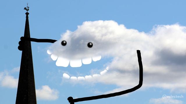 A photo of a large fluffy white cloud against a blue sky, with a church spire with a weather cock on top in silhouette on the left hand side. The cloud has a big gap, like a mouth, to which I have added big flat teeth so it looks like a big tooth grin. I have added eyes above, and arms either side, one reaching out and holding on to the spire. No idea why. It was just there.
