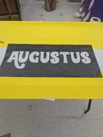 Test vinyl, Augustus. Black vinyl on yellow wrapping paper.