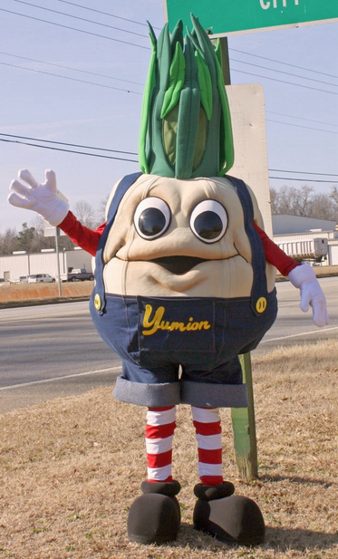 This is the reference for the above onion shaped mascot wearing red and white striped stockings, black boots, Jean overalls, with red sleeves abs white hands.